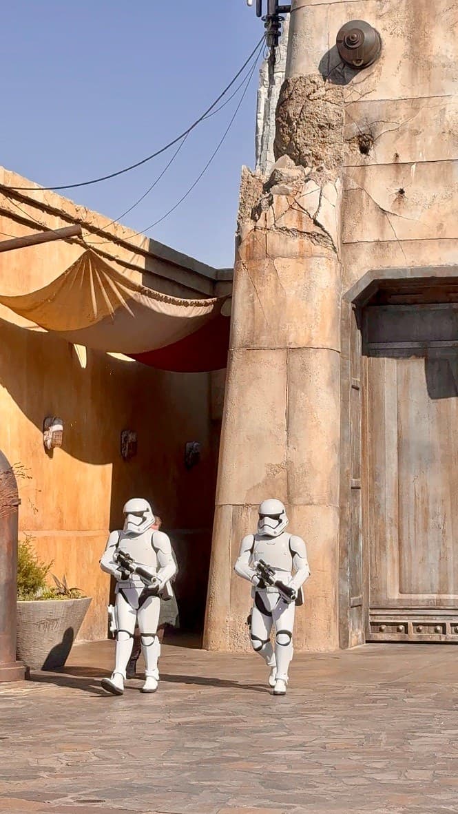 Two stormtroopers walking through Star Wars: Galaxy’s Edge in Florida.