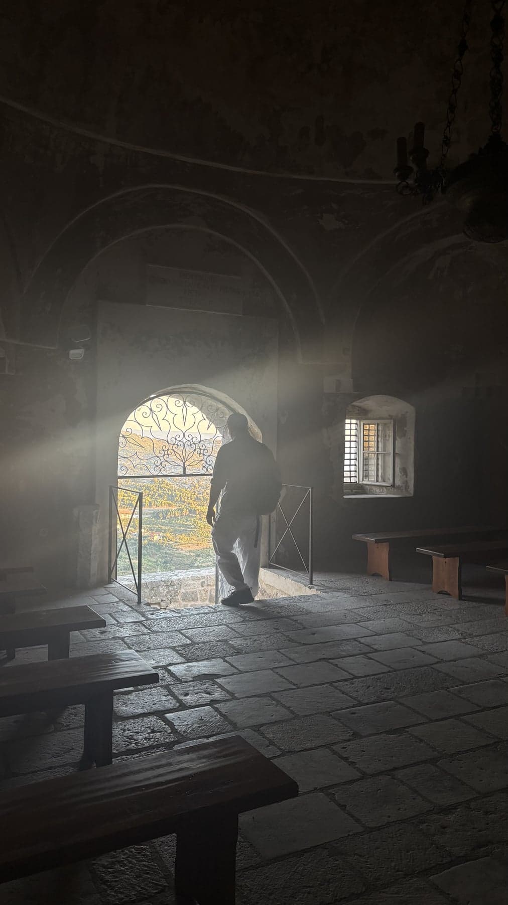 Light entering an old stone room at Klis Fortress through an open doorway