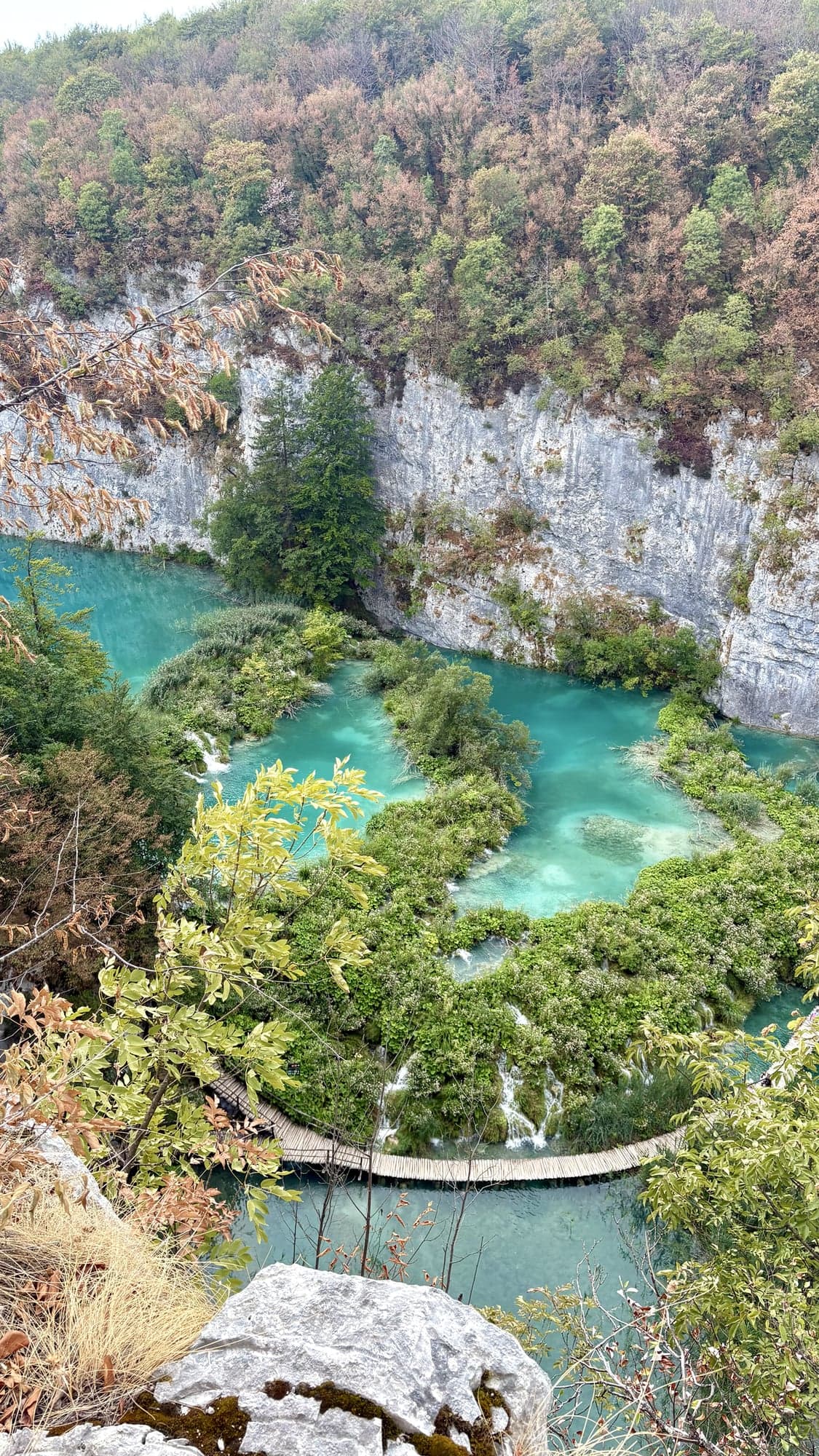 Turquoise lakes and wooden boardwalks seen from above at Plitvice Lakes